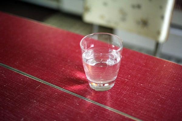 Cup of water on a red table