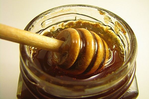 Jar of honey with spoon